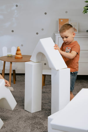 a soft white iglu foam block set arranged in a gentle, comforting play scene for toddlers