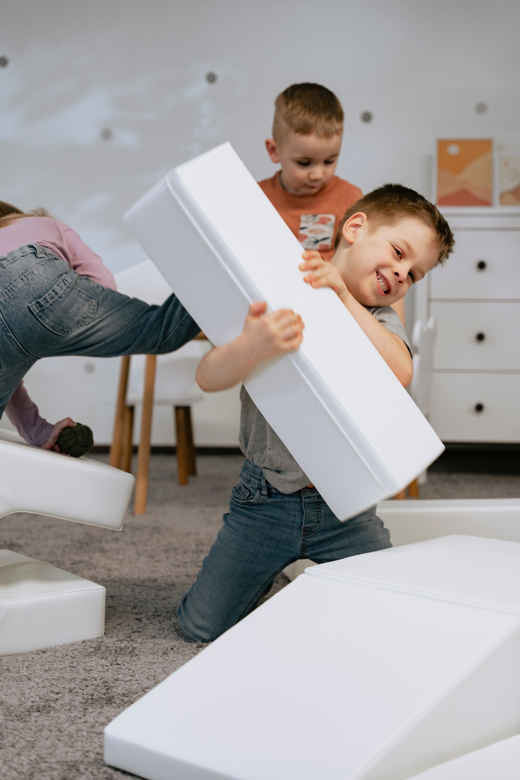 a child building a creative igloo fort with soft white foam blocks