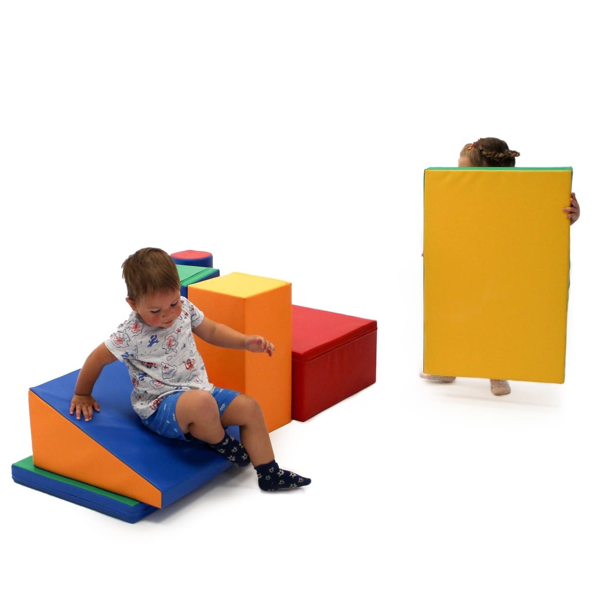 a child's hand reaching for a vibrant multicolor iglu foam block in soft morning light