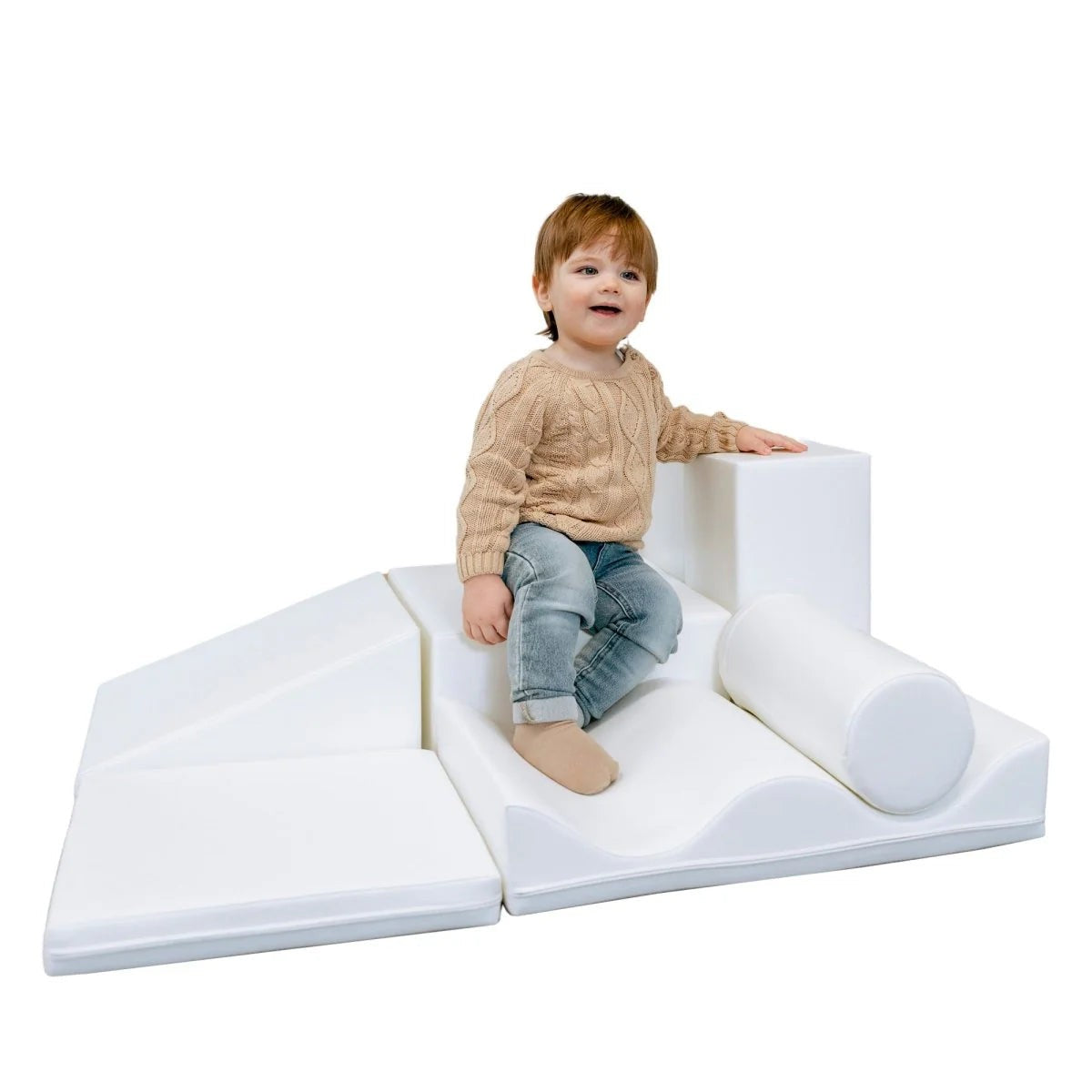 a child building a creative igloo fort with soft white foam blocks in a sunlit playroom