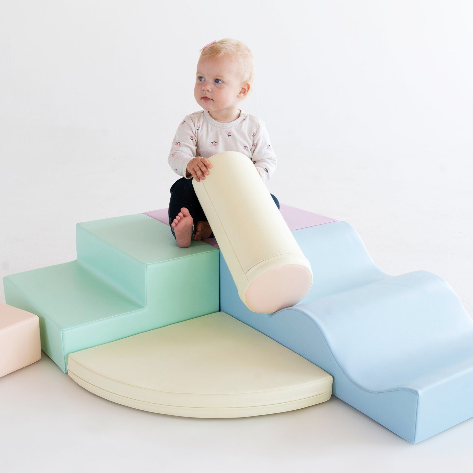 a toddler building a cozy pastel igloo fort with soft foam blocks
