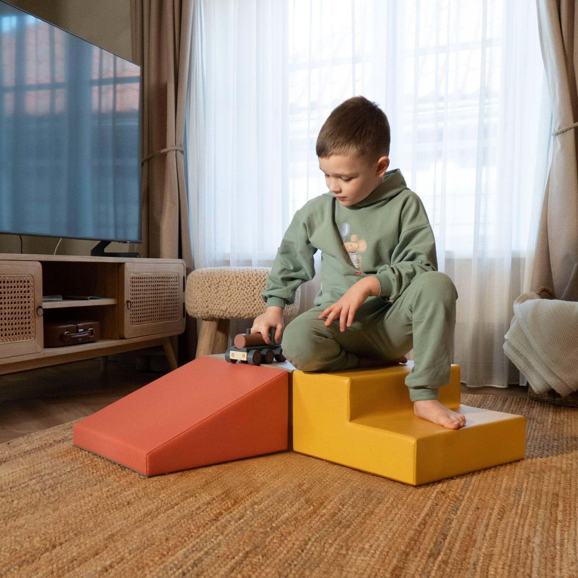 a soft pink foam climbing block set arranged in a gentle, inviting nest for a toddler's quiet play