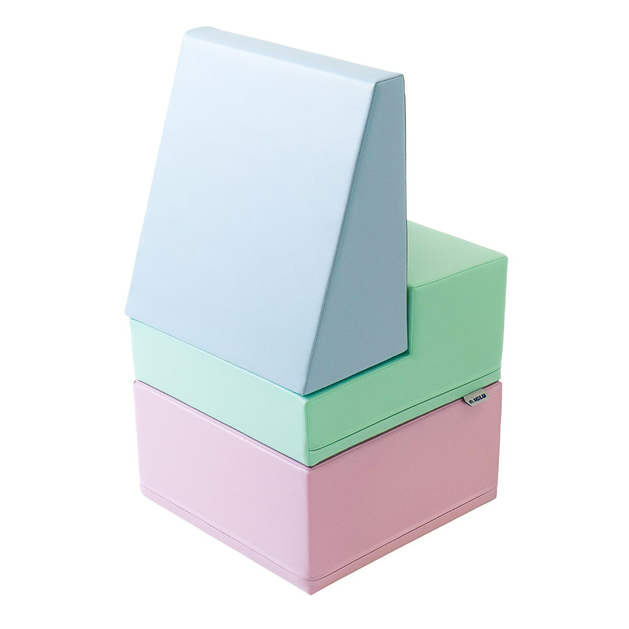a toddler's hand touching a soft pastel foam block in warm morning light