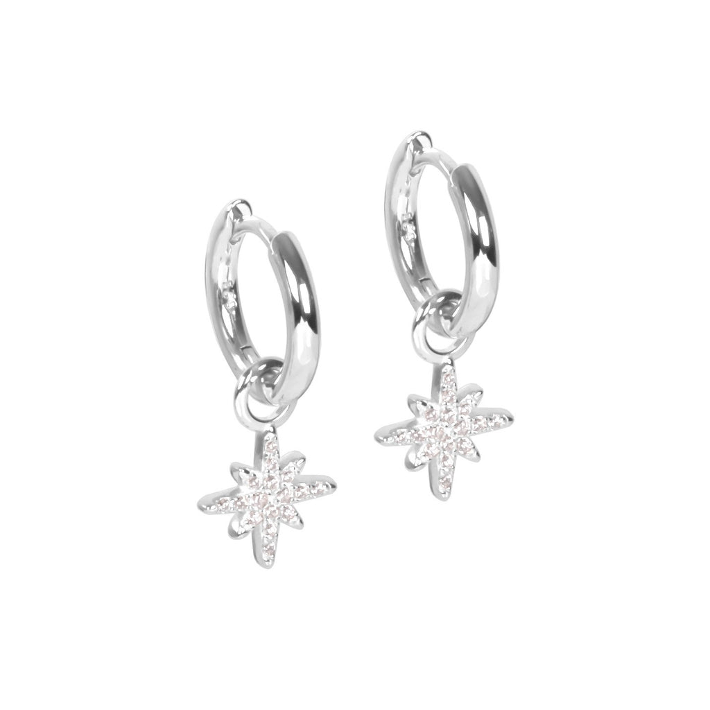 bold sterling silver star charm hoop earrings with a confident, close-up view on a dark background