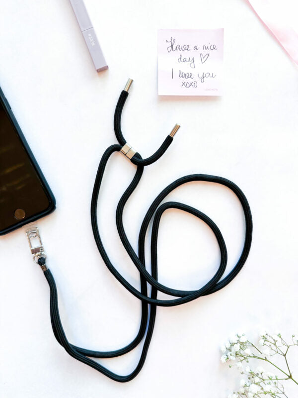 functional seik universal phone strap in midnight black attached to a phone case
