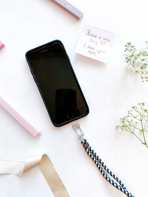 close-up of the sea edge phone strap attached to a smartphone, demonstrating its secure and practical grip