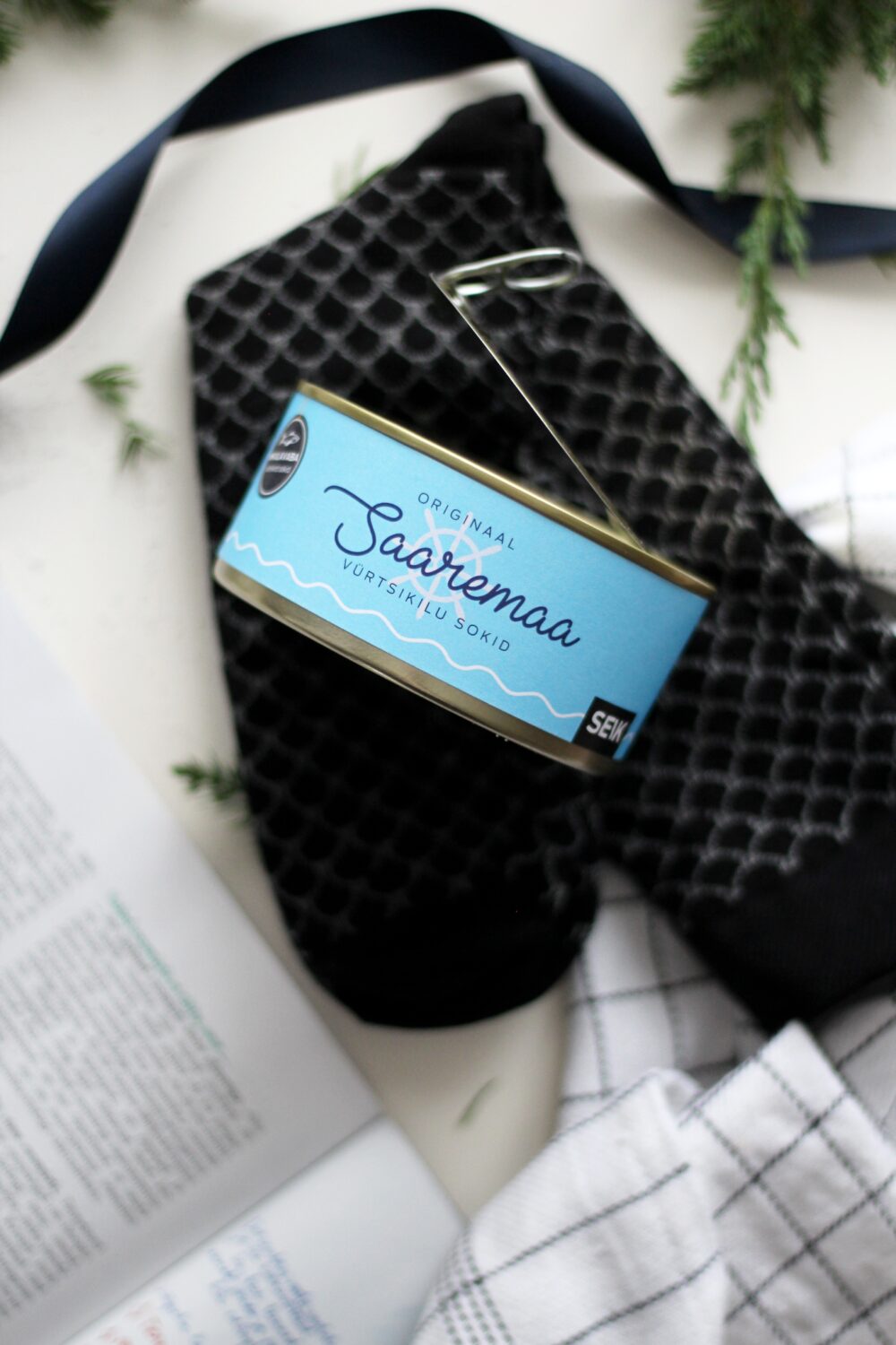 a man's feet in soft saaremaa herring socks resting on a wooden dock after a festival