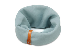 soft turquoise dog neck warmer in cozy indoor light