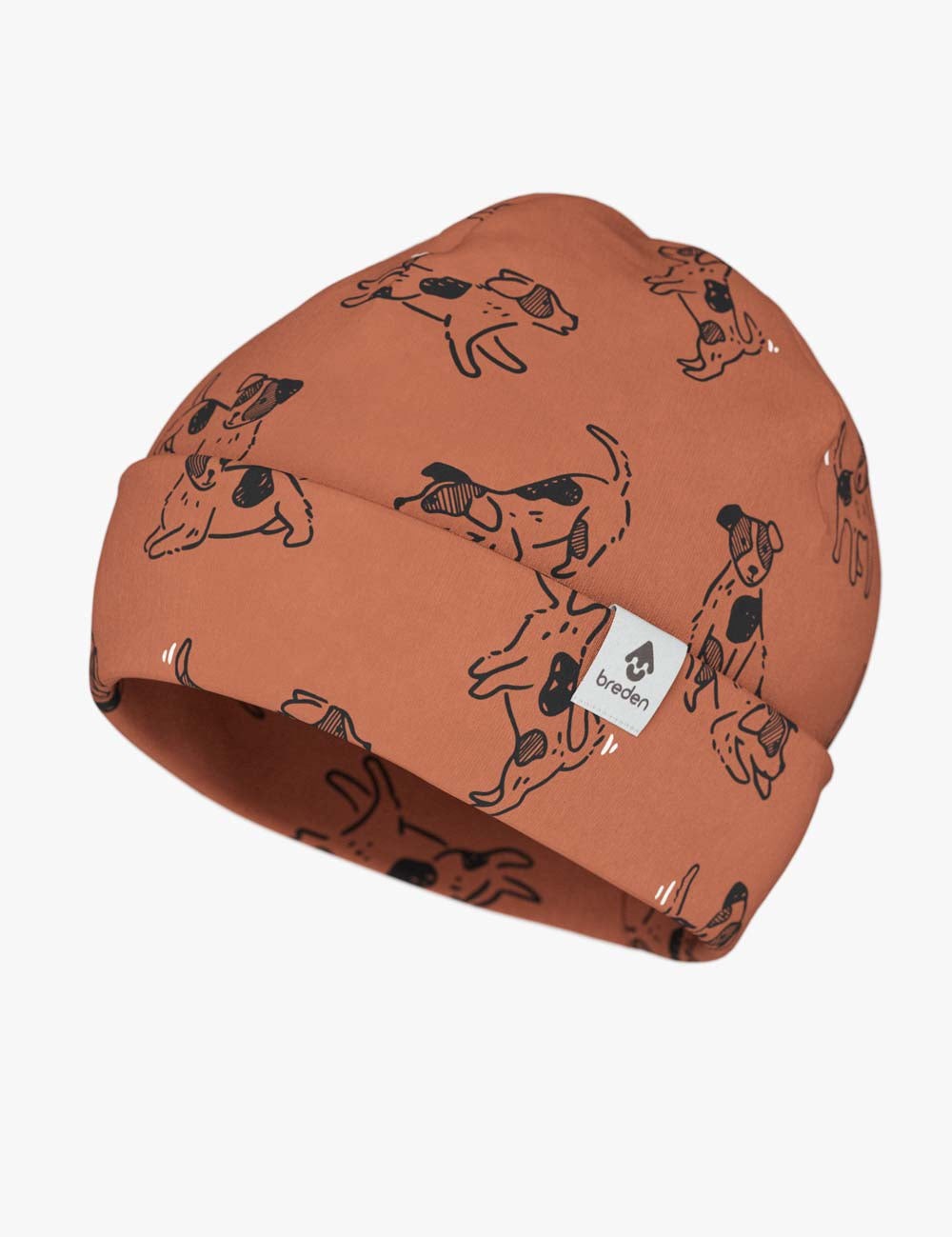 an elegant kids copper dog print beanie with a folded brim, resting on a soft leather background