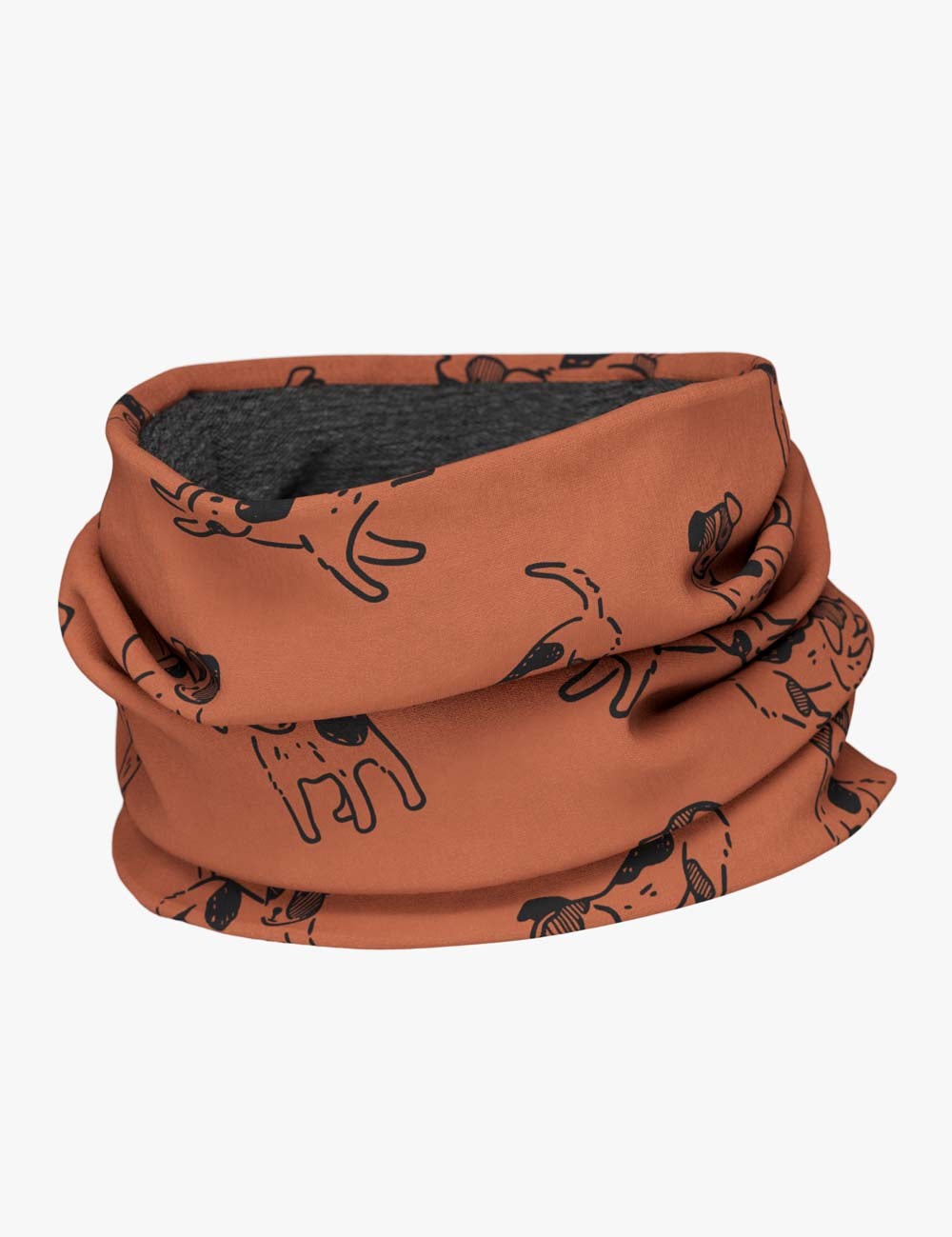a child laughing while wearing the copper dogs merino neck tube in a sunlit garden