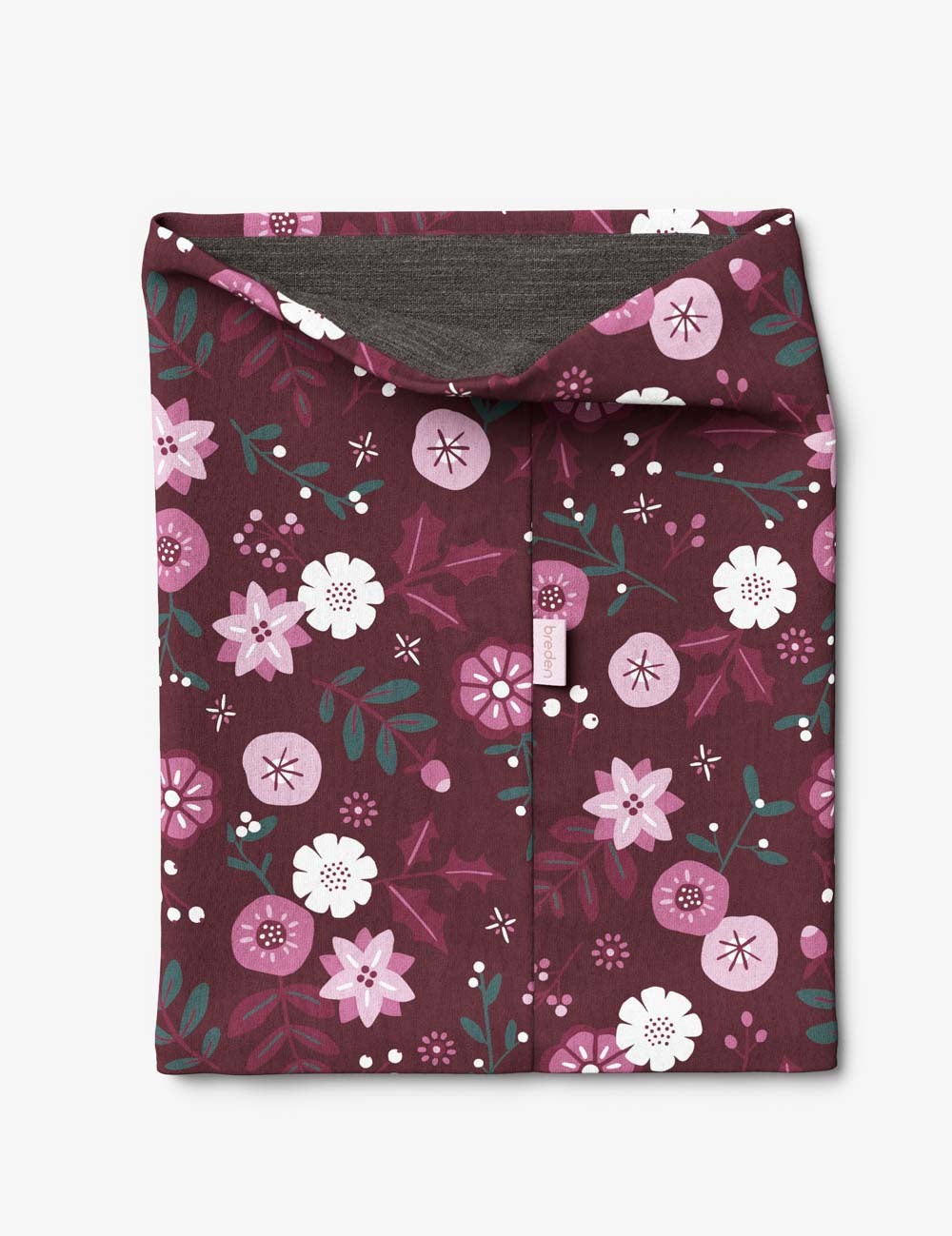 elegant kids merino neck tube with winter flowers, displayed on a textured craft leather background