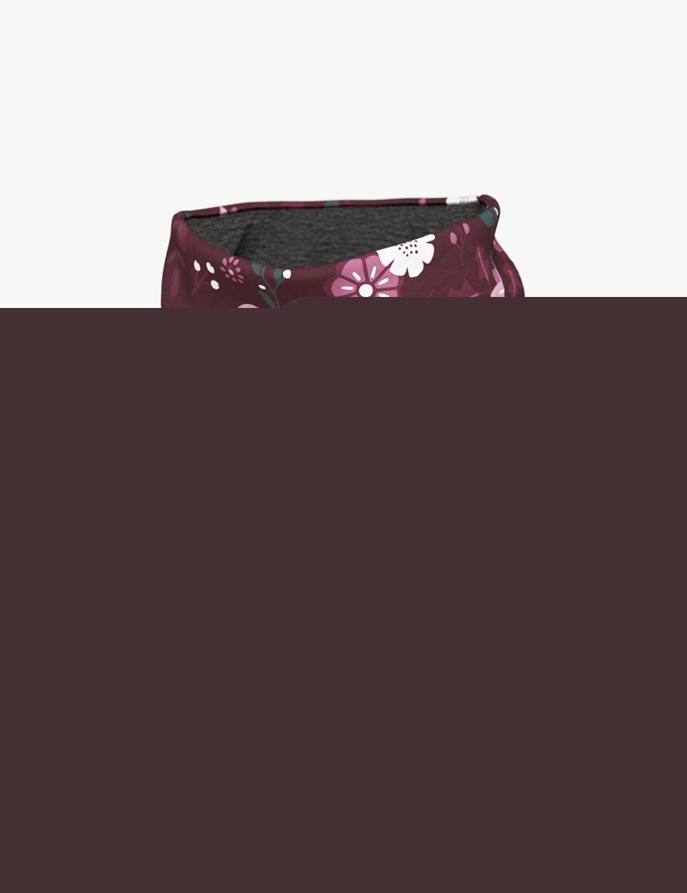 a soft kids merino neck warmer with a delicate winter flowers pattern, shown in gentle morning light