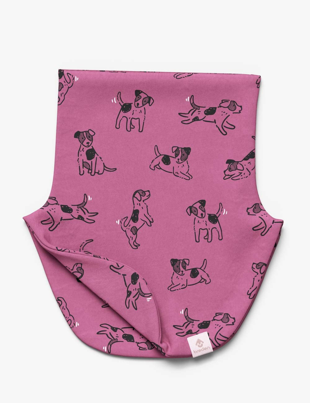 a soft pink kids neck warmer with a playful dog print, shown in gentle morning light
