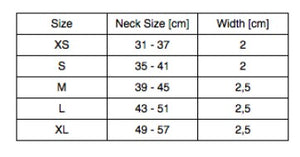 a soft black italian leather dog collar with a gentle sheen, resting on a cozy fabric