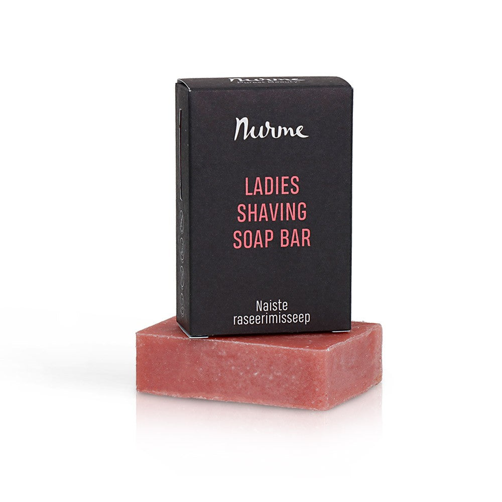 a bold close-up of a ladies vegan shaving soap bar with visible shea butter swirls