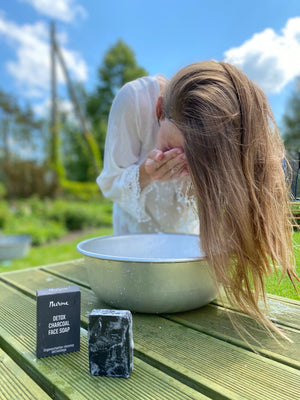 a soft, comforting close-up of our estonian goat's milk and charcoal facial cleansing bar on a natural linen towel