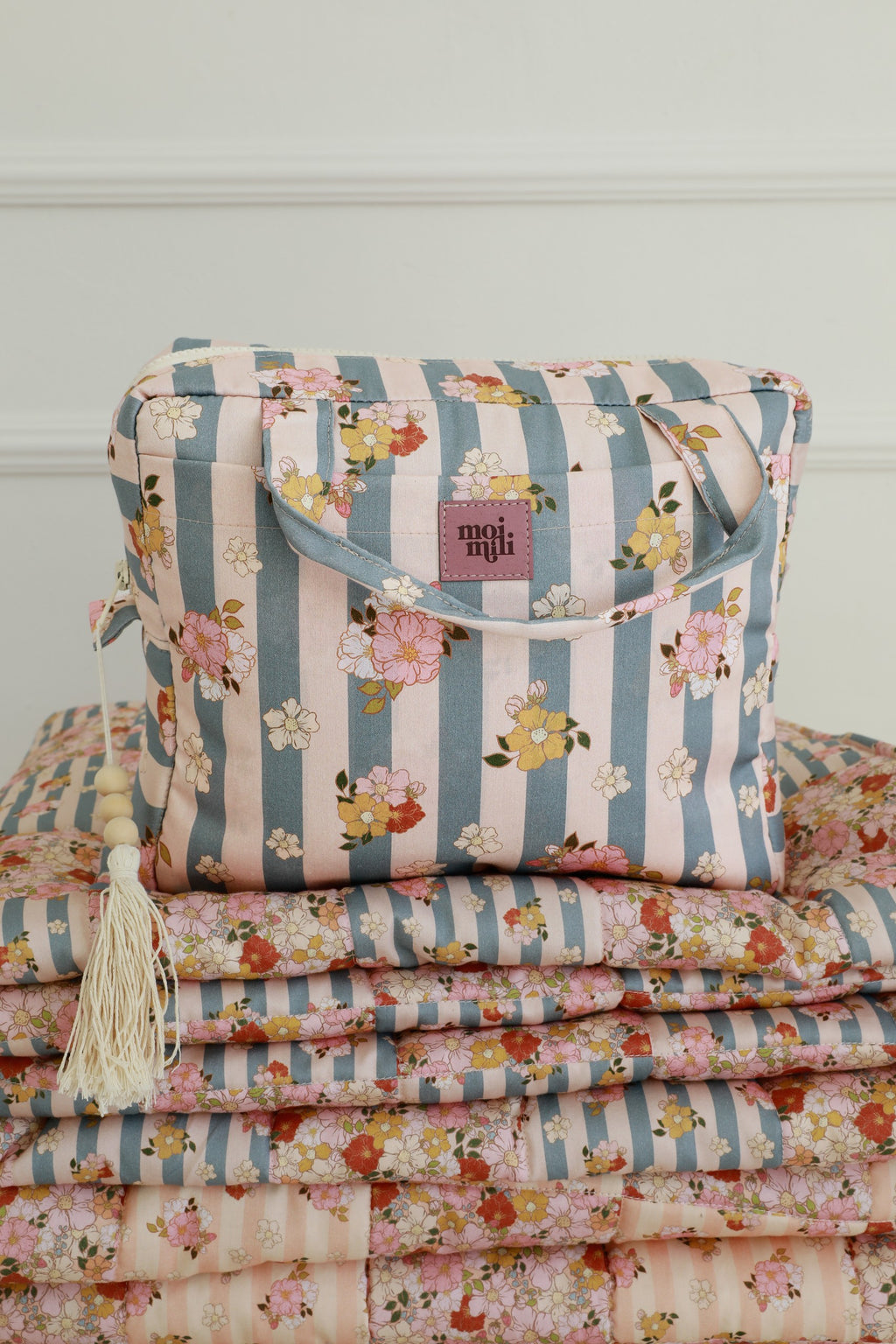 bold blue striped makeup bag with waterproof lining, open to show spacious interior and pockets
