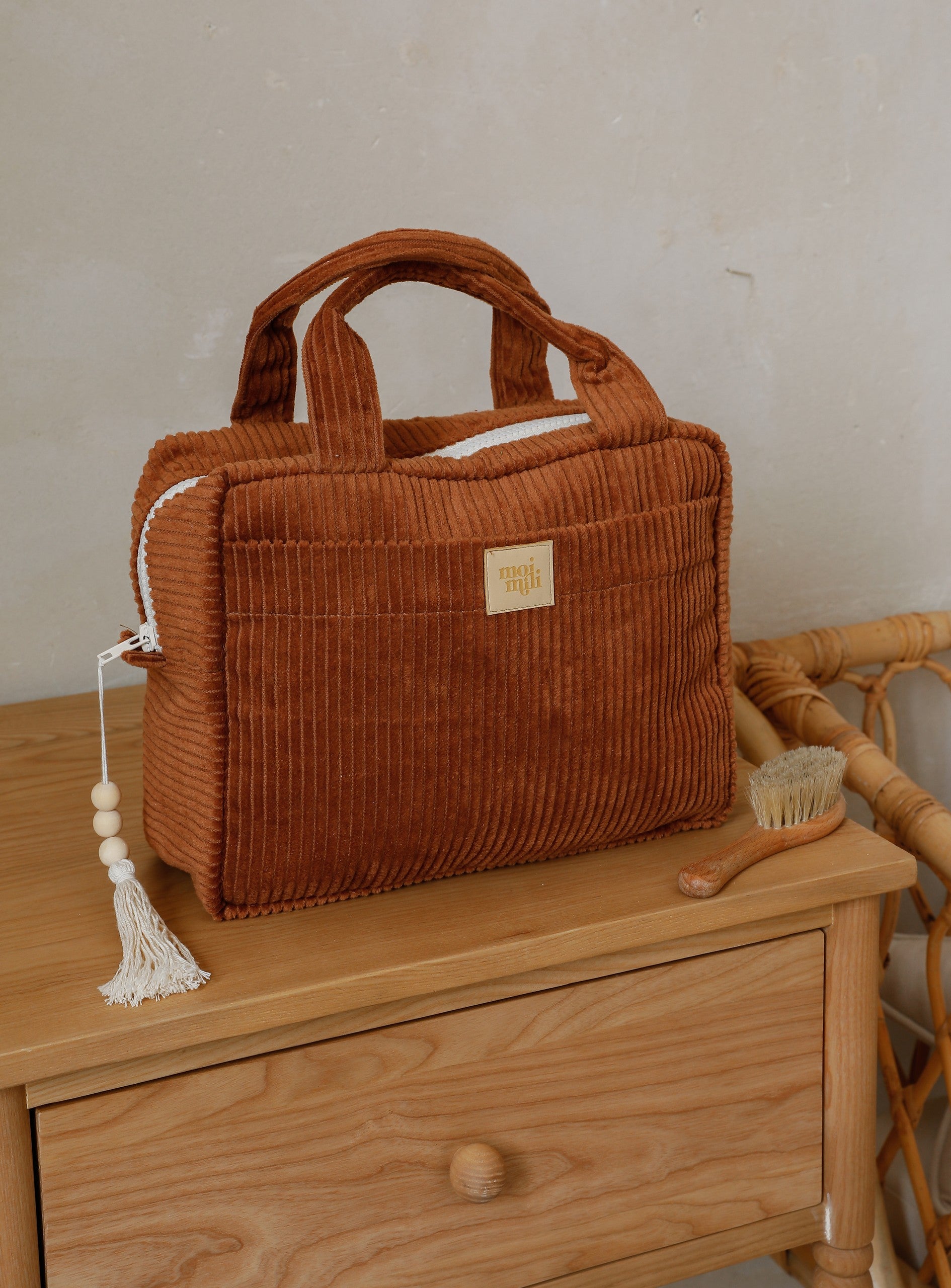 open caramel makeup bag showing its inner pocket and waterproof lining for practical organization