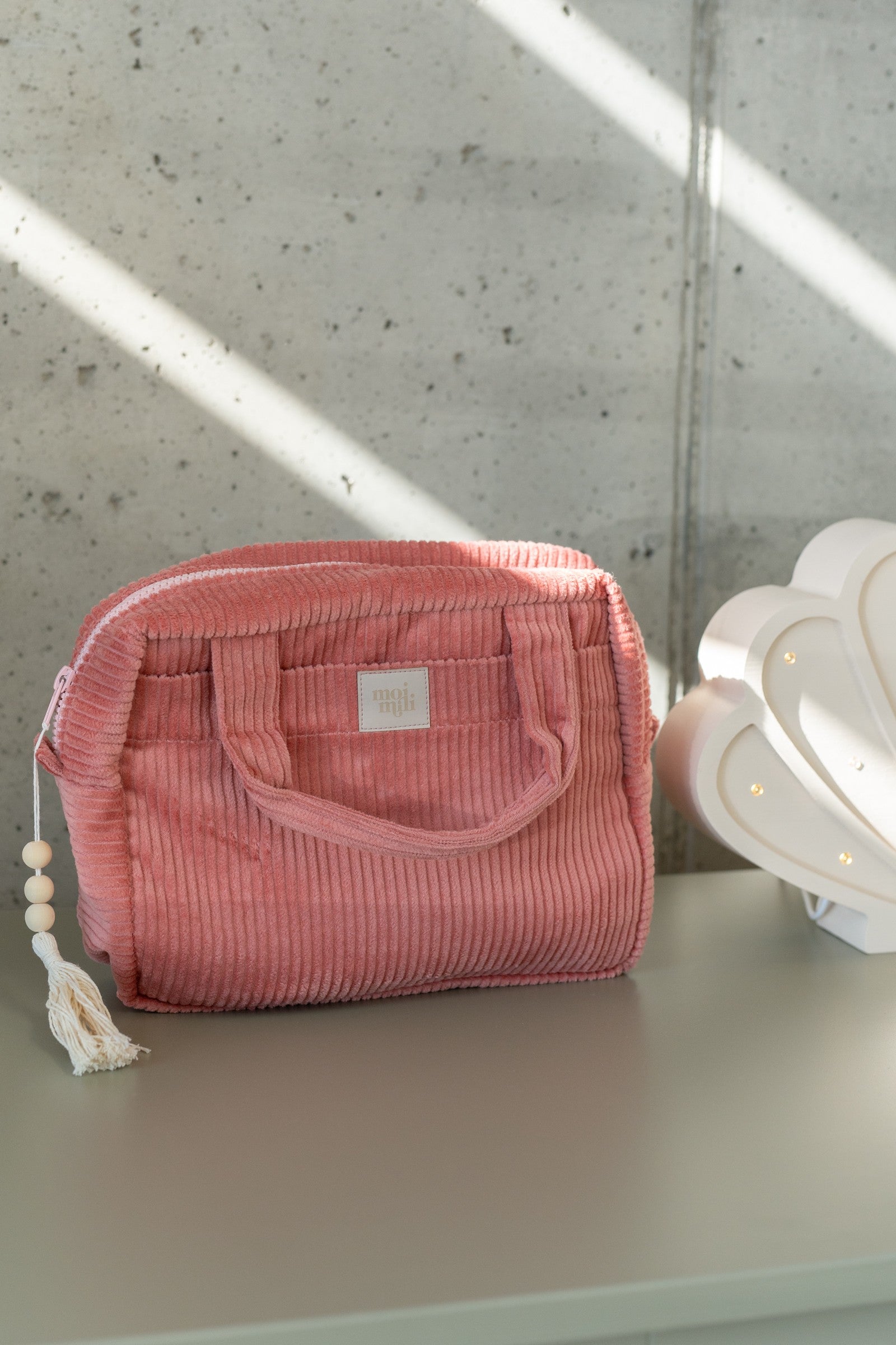 playful coral makeup bag with waterproof lining, open to show inner pockets, perfect for travel or daily use