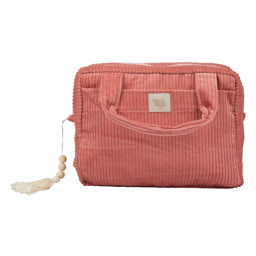 coral makeup bag with waterproof lining and dual pockets, held open to show spacious interior, perfect for travel essentials