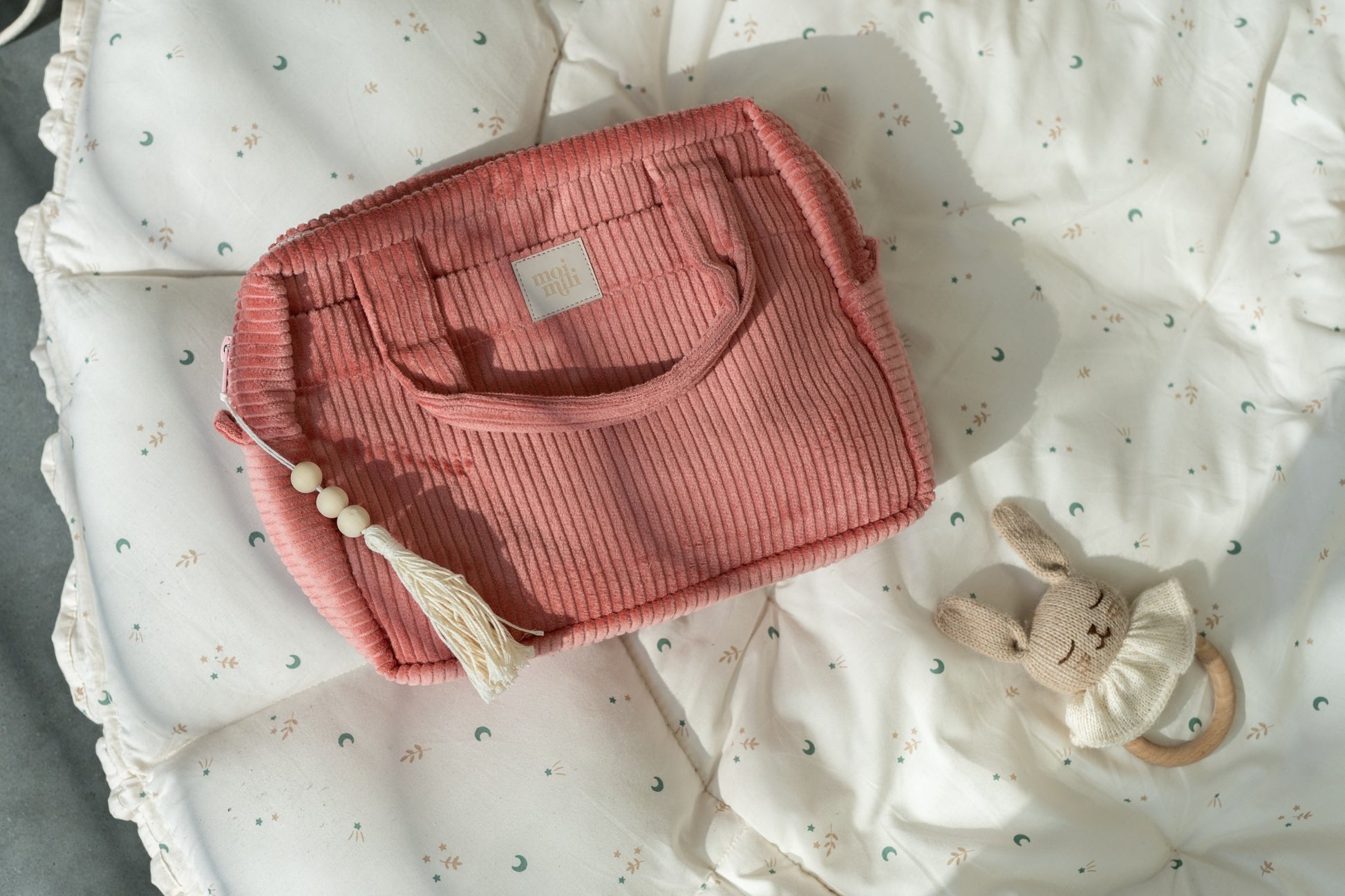 elegant coral makeup bag with waterproof lining, open to reveal inner pockets, perfect for travel or daily use