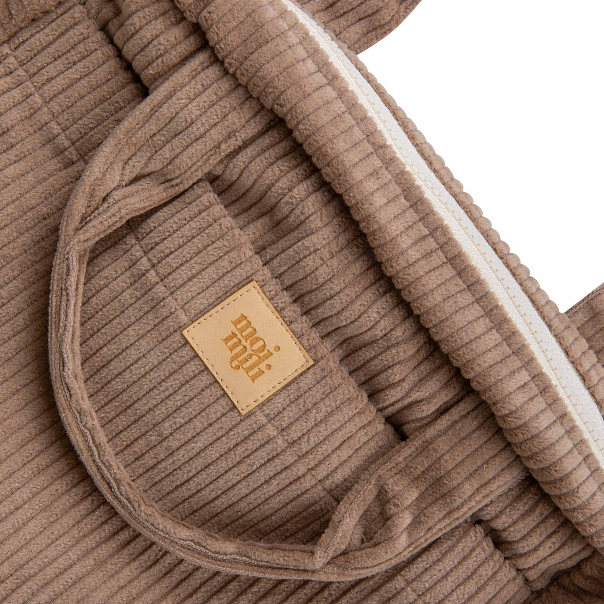 elegant latte makeup bag set displayed on a marble surface, showcasing its refined cotton texture and sophisticated design