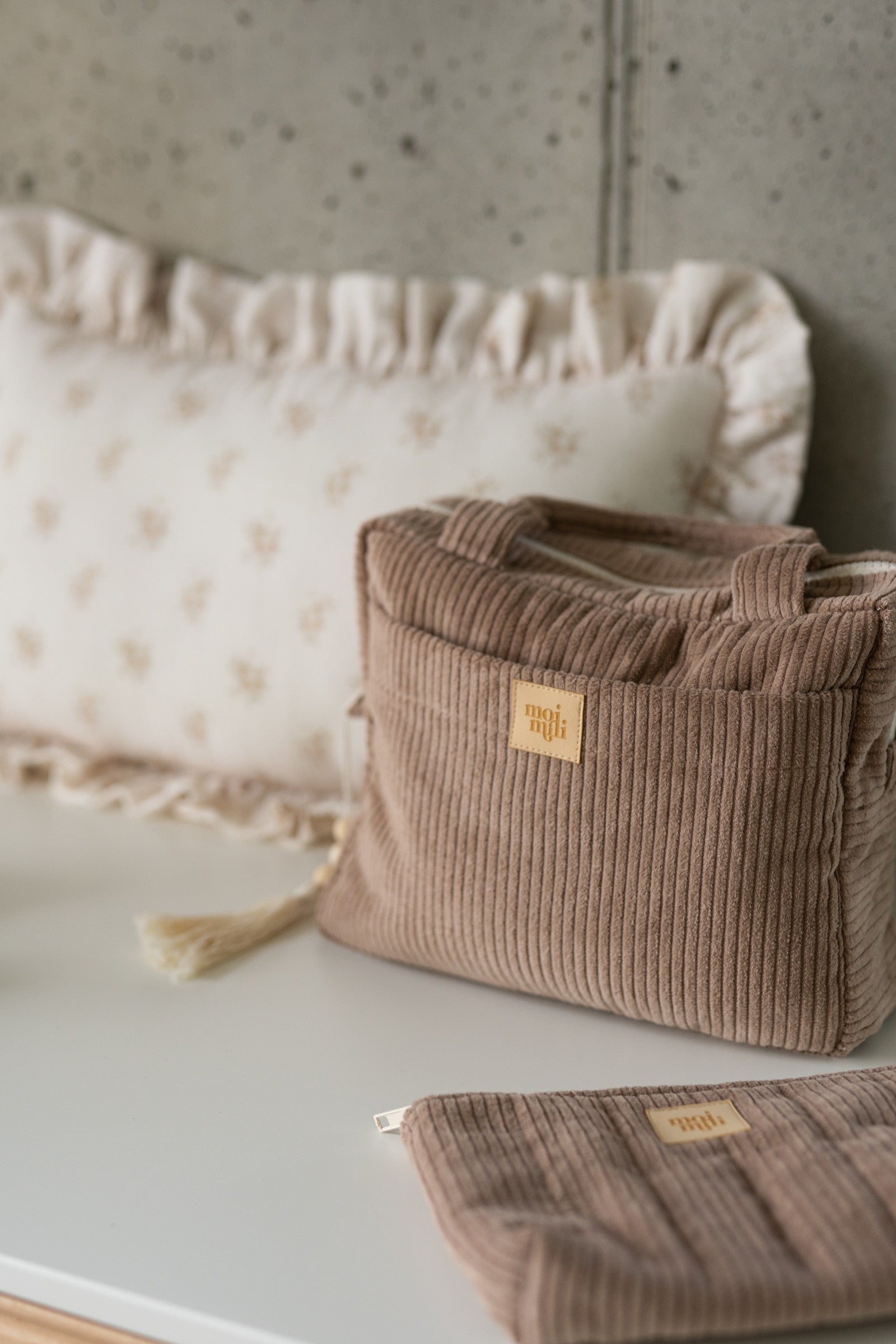 moi mili latte makeup bag set open on a table showing its waterproof lining and inner pocket organization