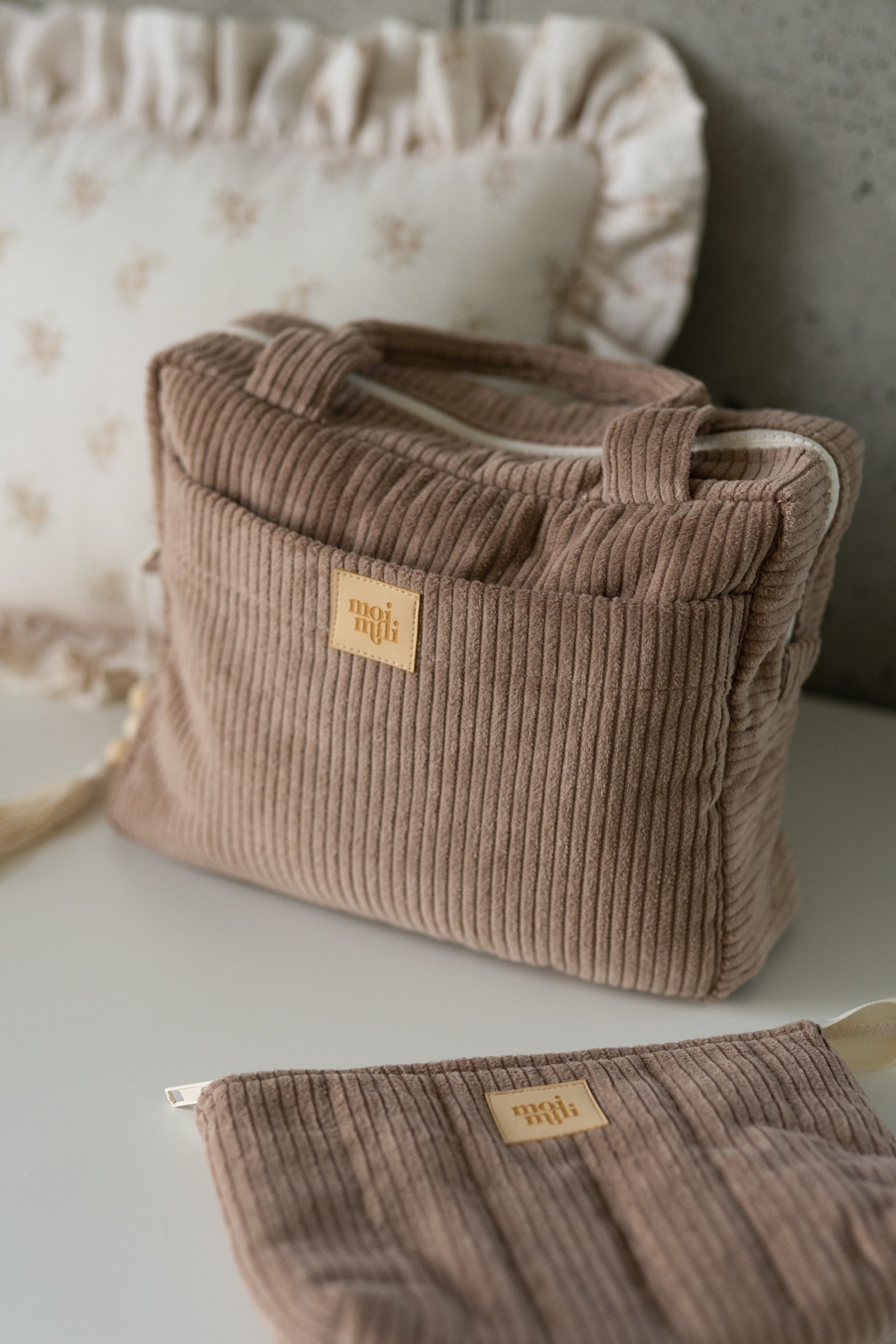 practical latte makeup bag set open on a table showing its inner and outer pockets