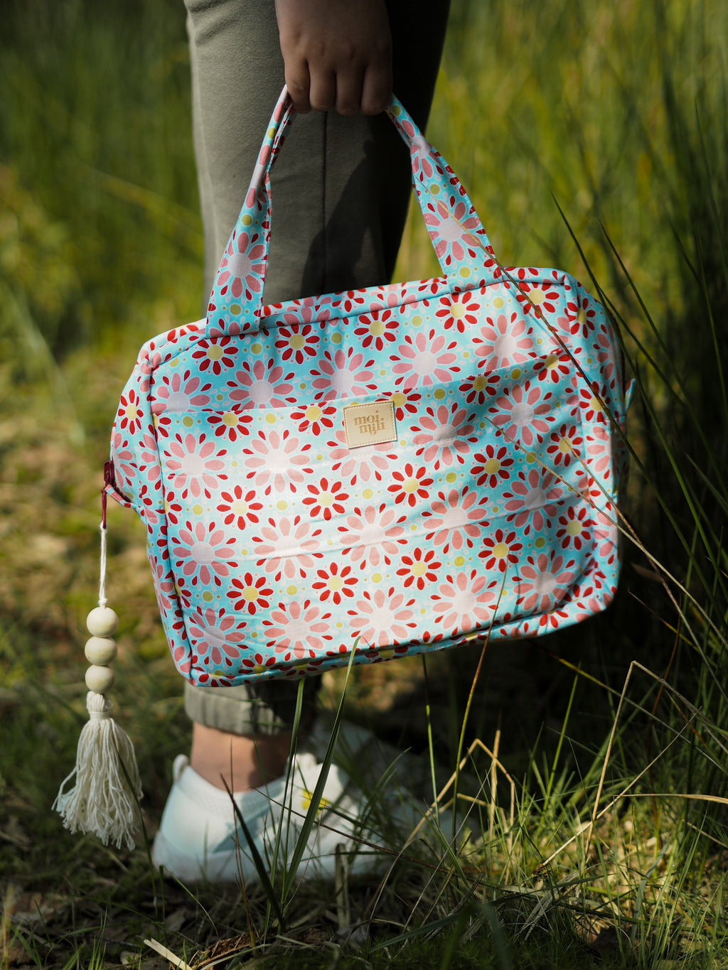 red floral cotton makeup bag with waterproof lining, open to show inner pockets, practical for travel