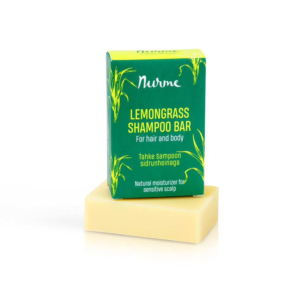 a soft-focus close-up of a lemongrass shampoo bar resting on a gentle green leaf