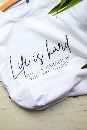 a woman relaxing in a soft oversized life is hard t-shirt with comforting morning light