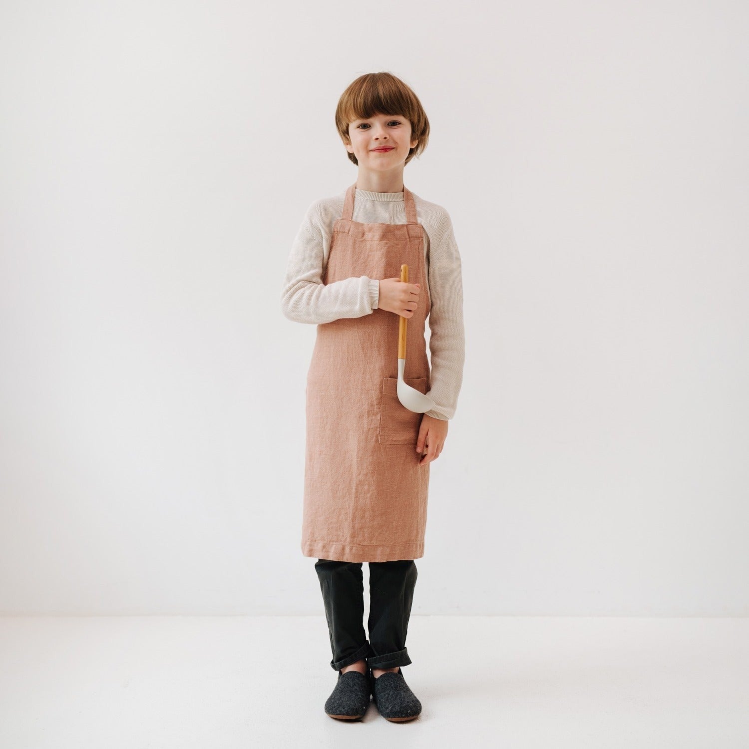 soft cafe creme linen kids apron with front pocket, tied at the waist for messy kitchen adventures