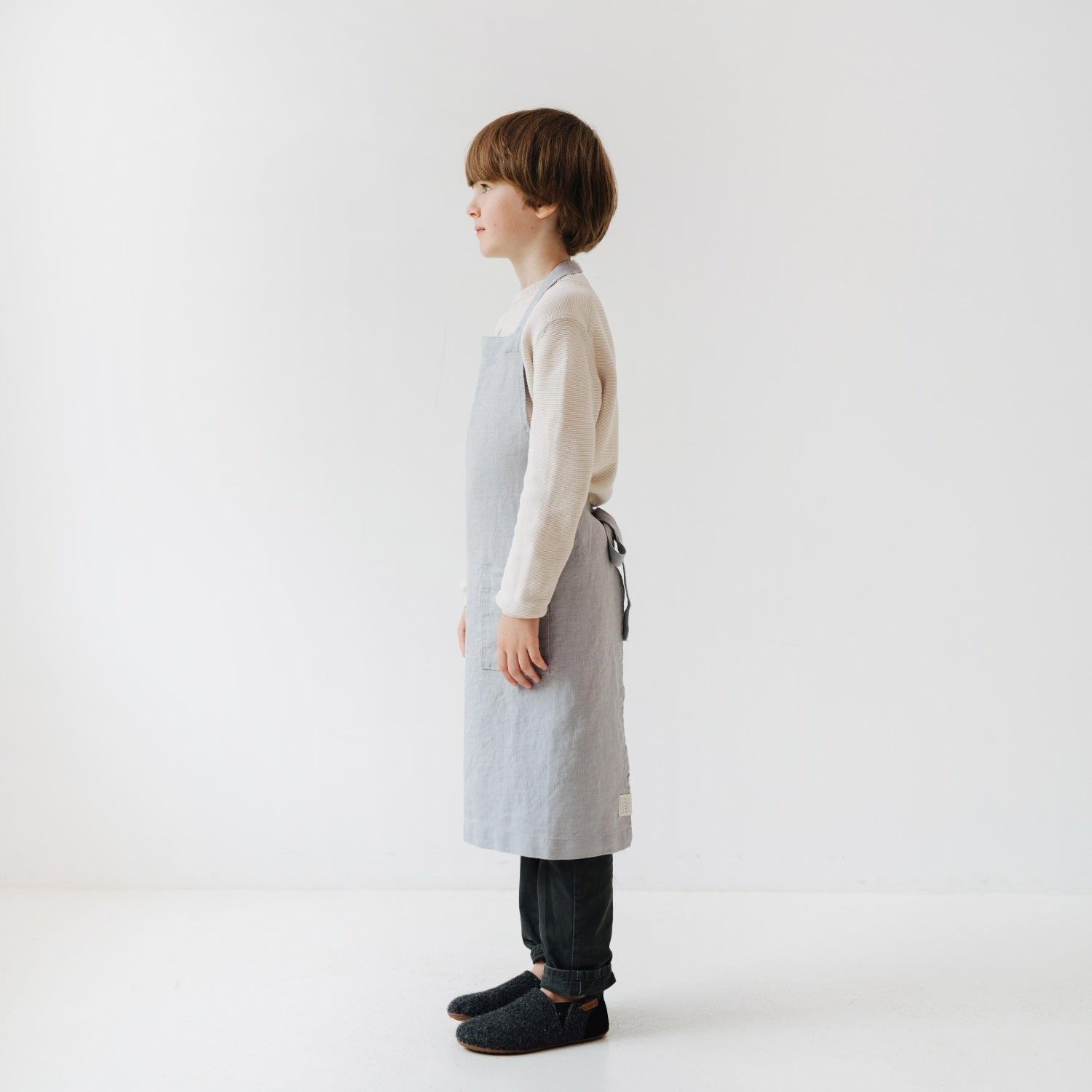 confident young chef in a stone-washed grey linen apron with a front pocket