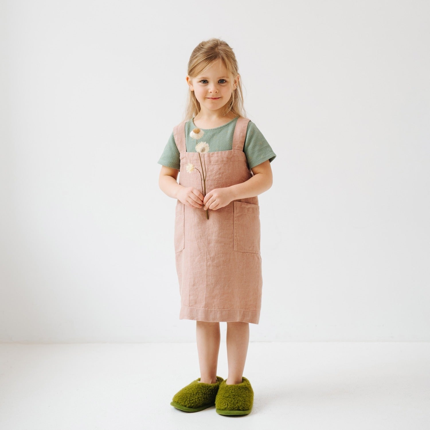 functional kids linen pinafore apron in cafe creme, showing front pockets and easy slip-on design for messy kitchen fun