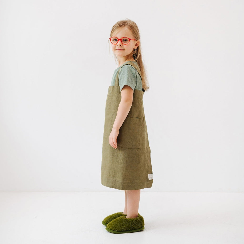 bold olive linen pinafore apron for kids with front pockets, no ties, ready for kitchen adventures