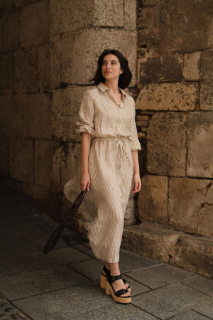 confident woman in bronze white striped linen dress with side splits, bold daytime look