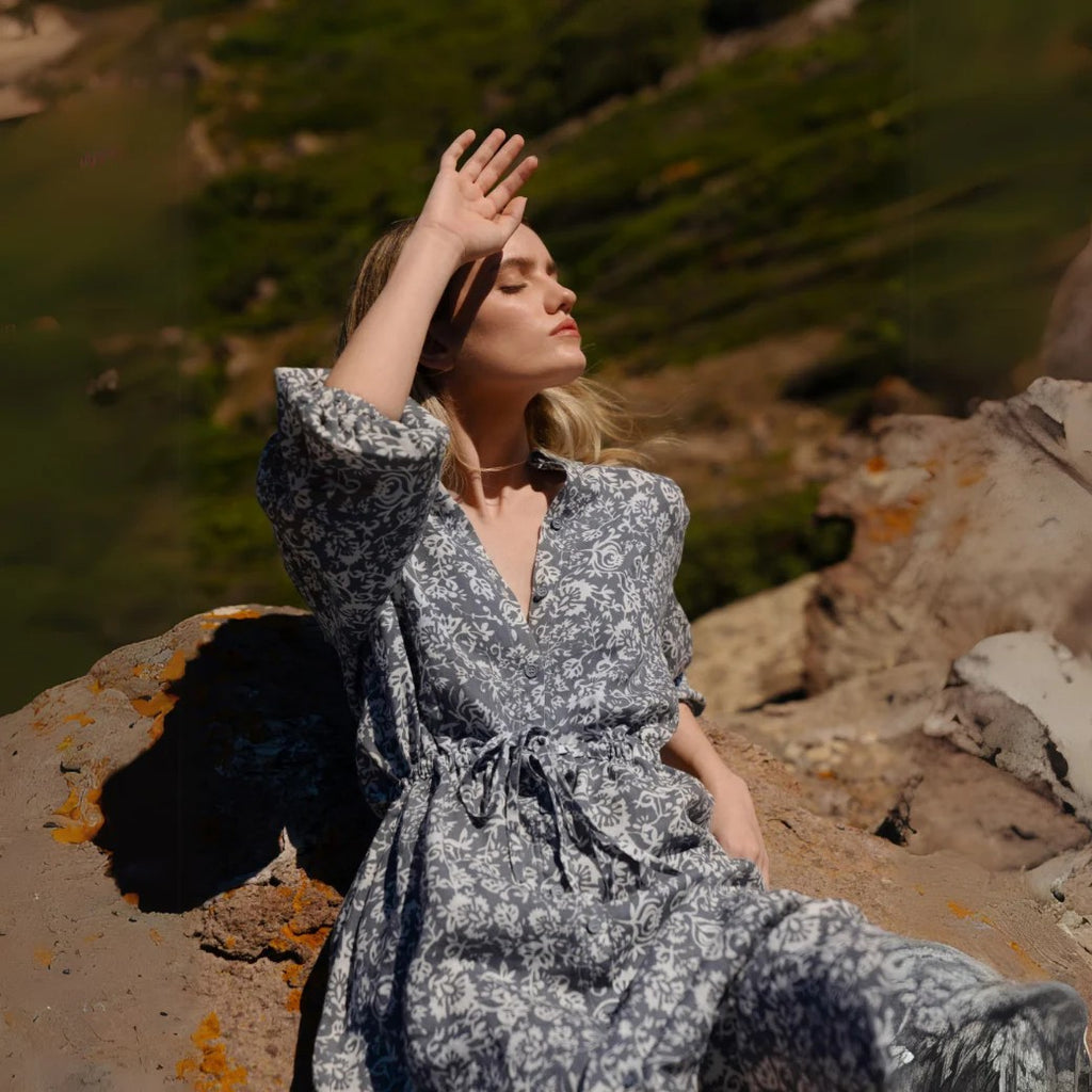 playful twirl in a linen dress with porcelain flowers and a playful pet companion