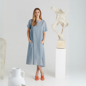 confident woman in a bold linen allure dress with back button detail