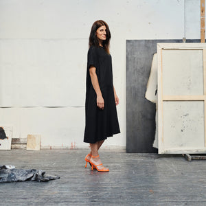 soft black linen dress with a-line silhouette in gentle morning light