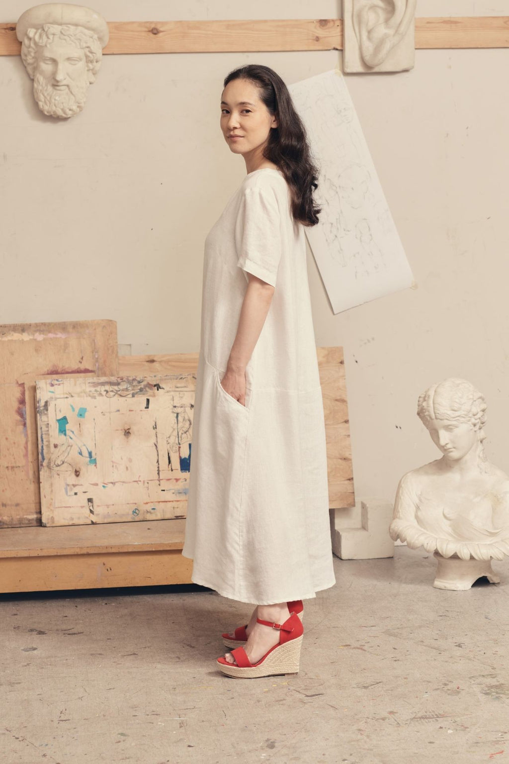 a soft, comforting close-up of the linen speedwell dress in optical white, highlighting its stone-washed texture