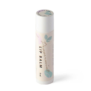 a bold close-up of our peppermint lip balm tin glowing with a cool, invigorating light