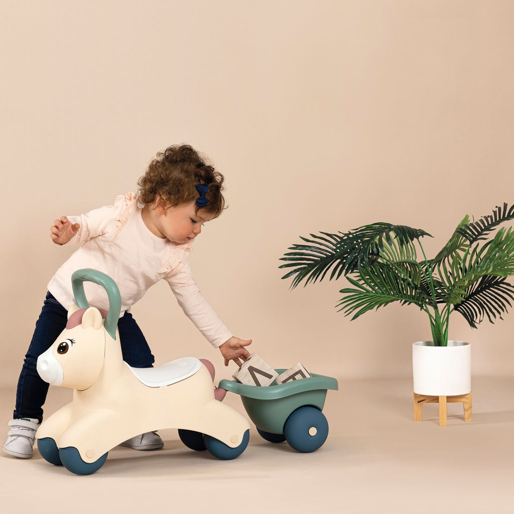 playful pastel pony ride-on with tiny trailer, perfect for toddlers learning to walk and balance