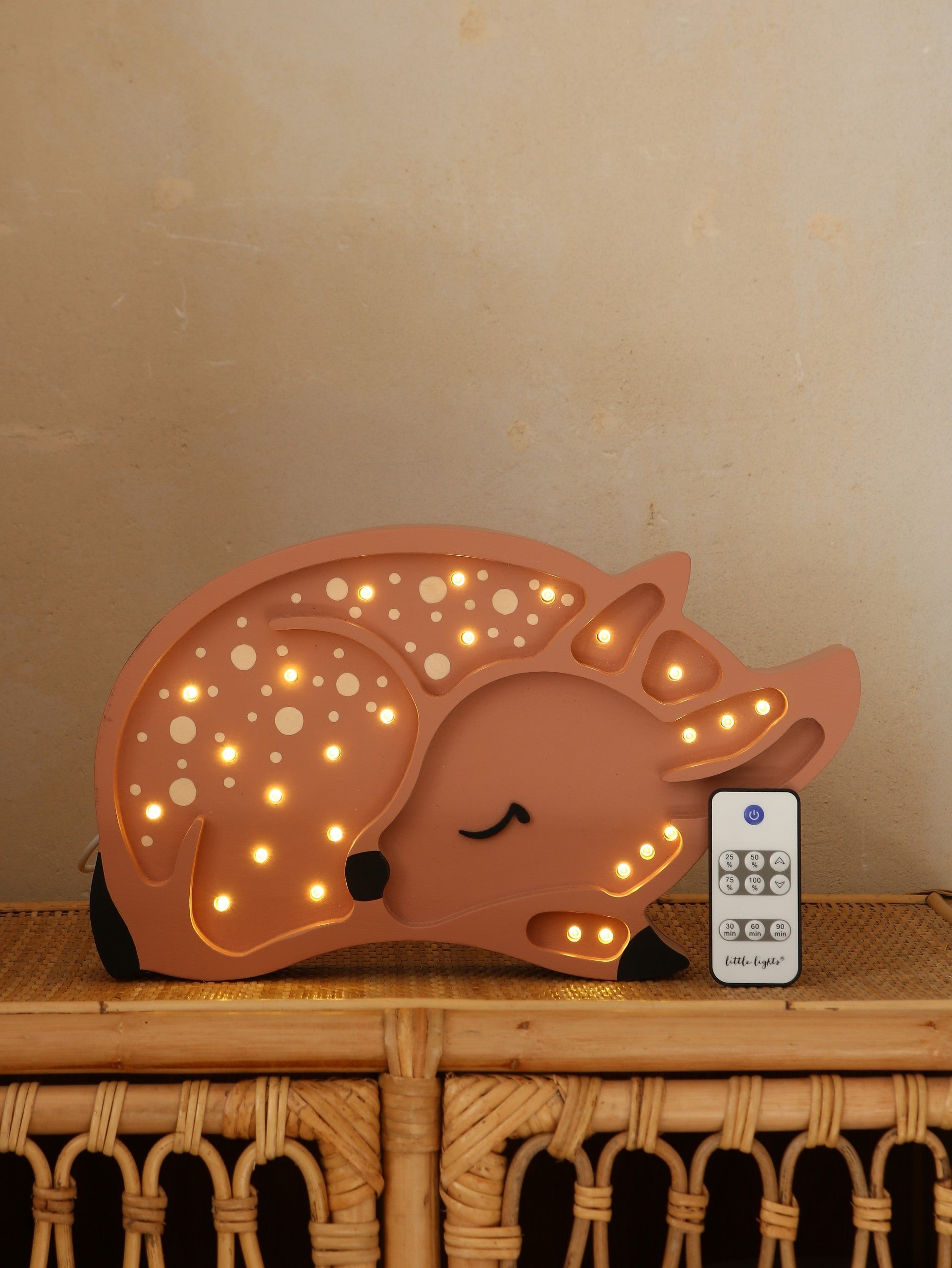bold artisan deer lamp casting a warm glow on a modern nursery shelf