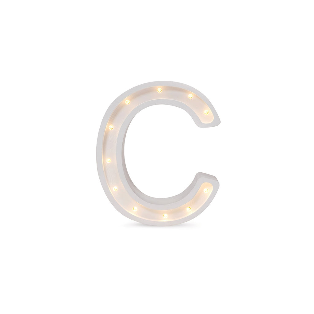 bold close-up of the handmade letter c lamp glowing warmly in a dark nursery