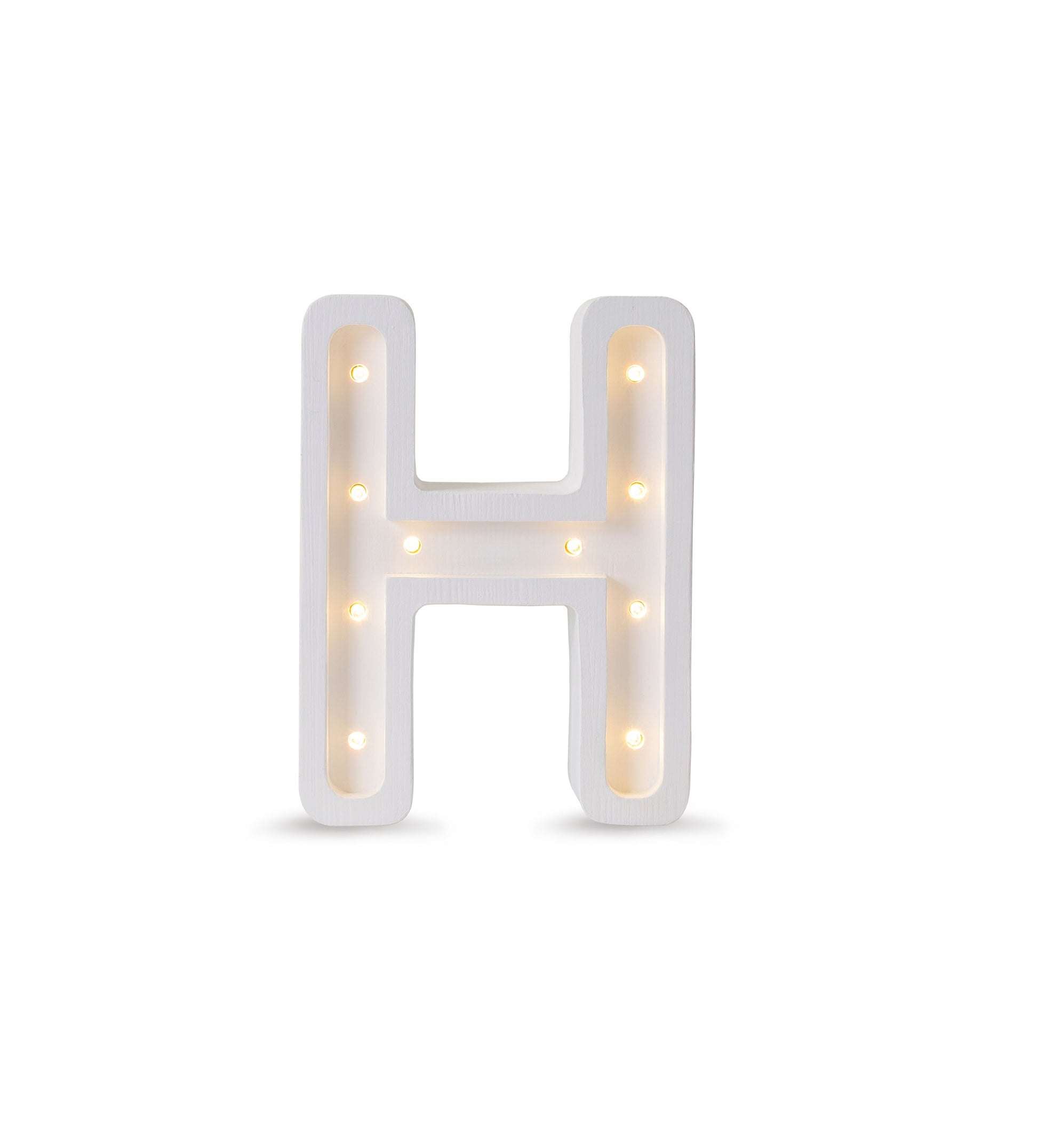 bold solid pinewood letter h lamp glowing warmly on a dark wood surface
