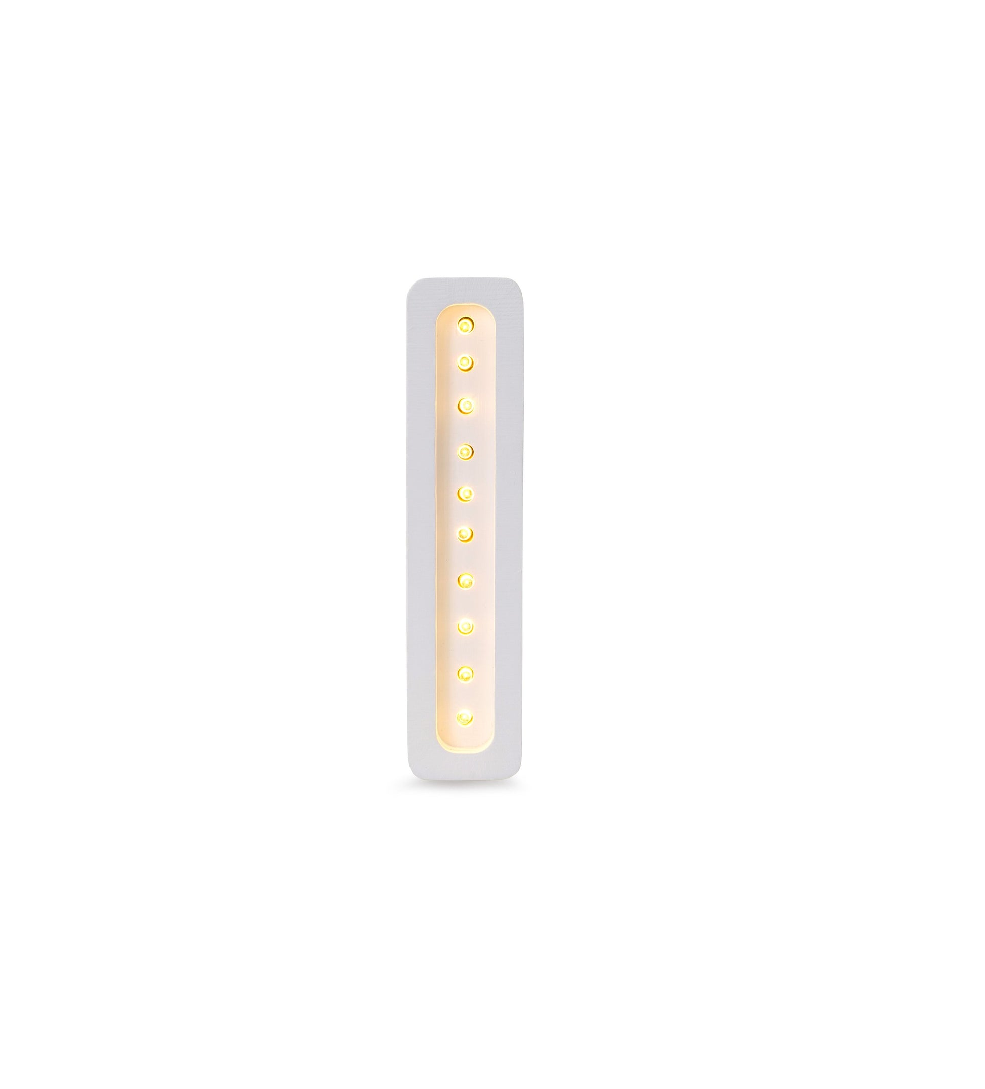 bold solid pinewood letter i lamp glowing confidently in a dark nursery