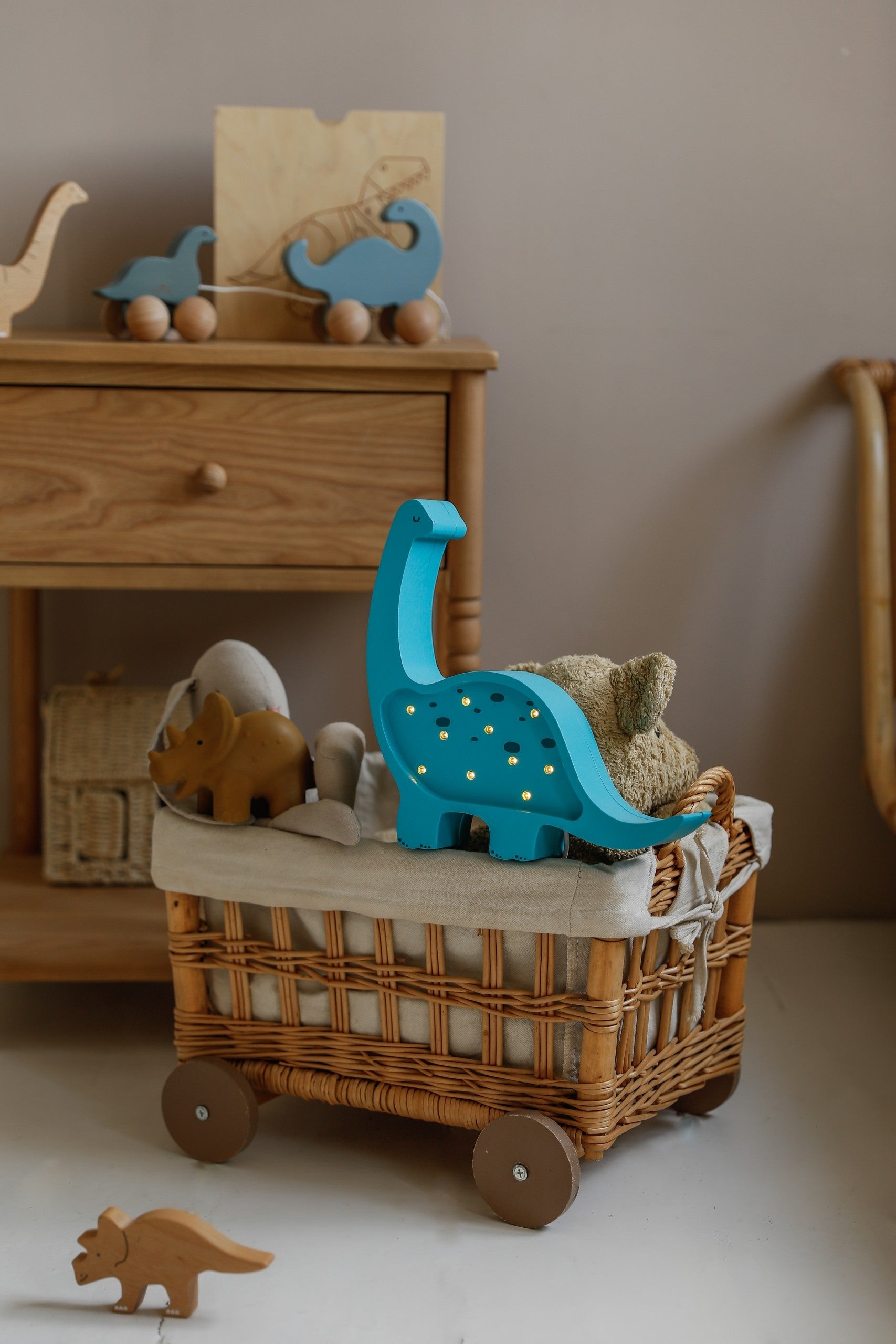 bold front view of a solid pinewood mini dino lamp with a confident warm glow