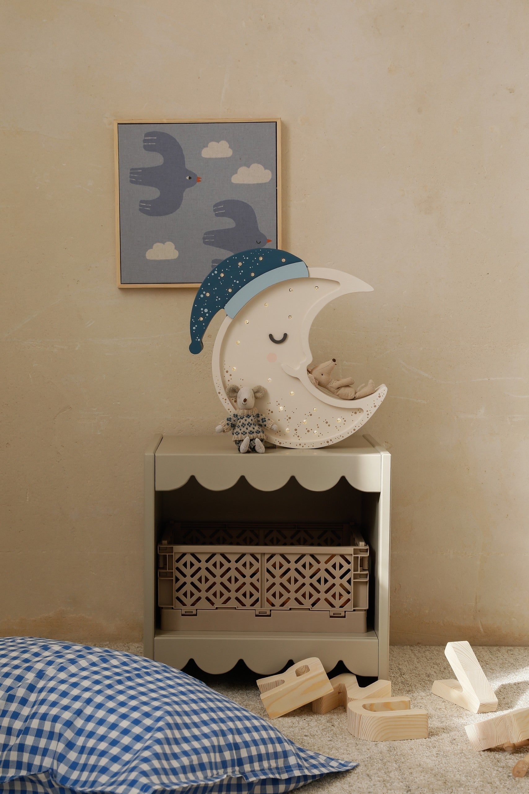handcrafted pinewood moon lamp casting a soft warm glow on a bedside table