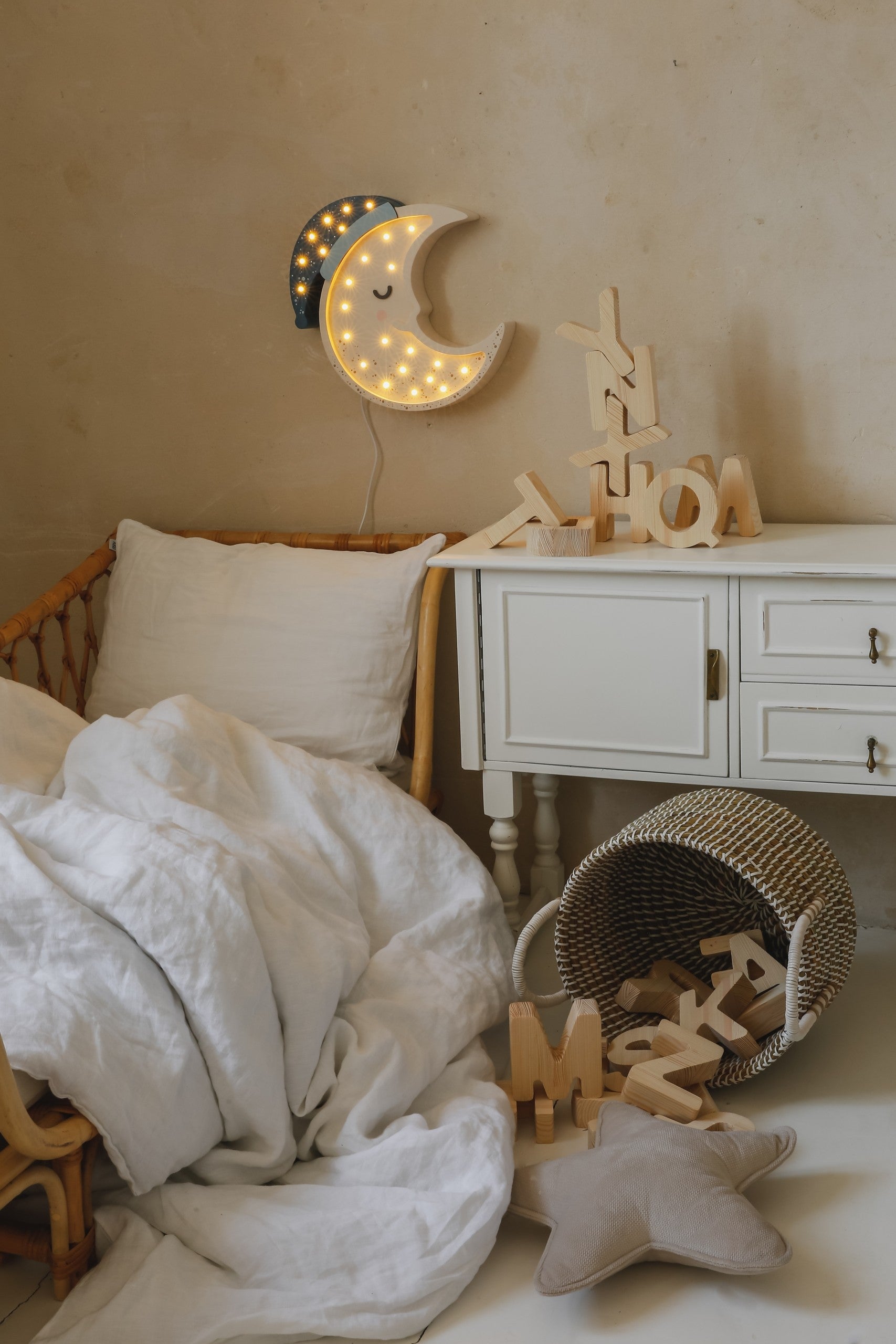 handcrafted pine wood moon lamp casting a warm glow on a childs bedside table