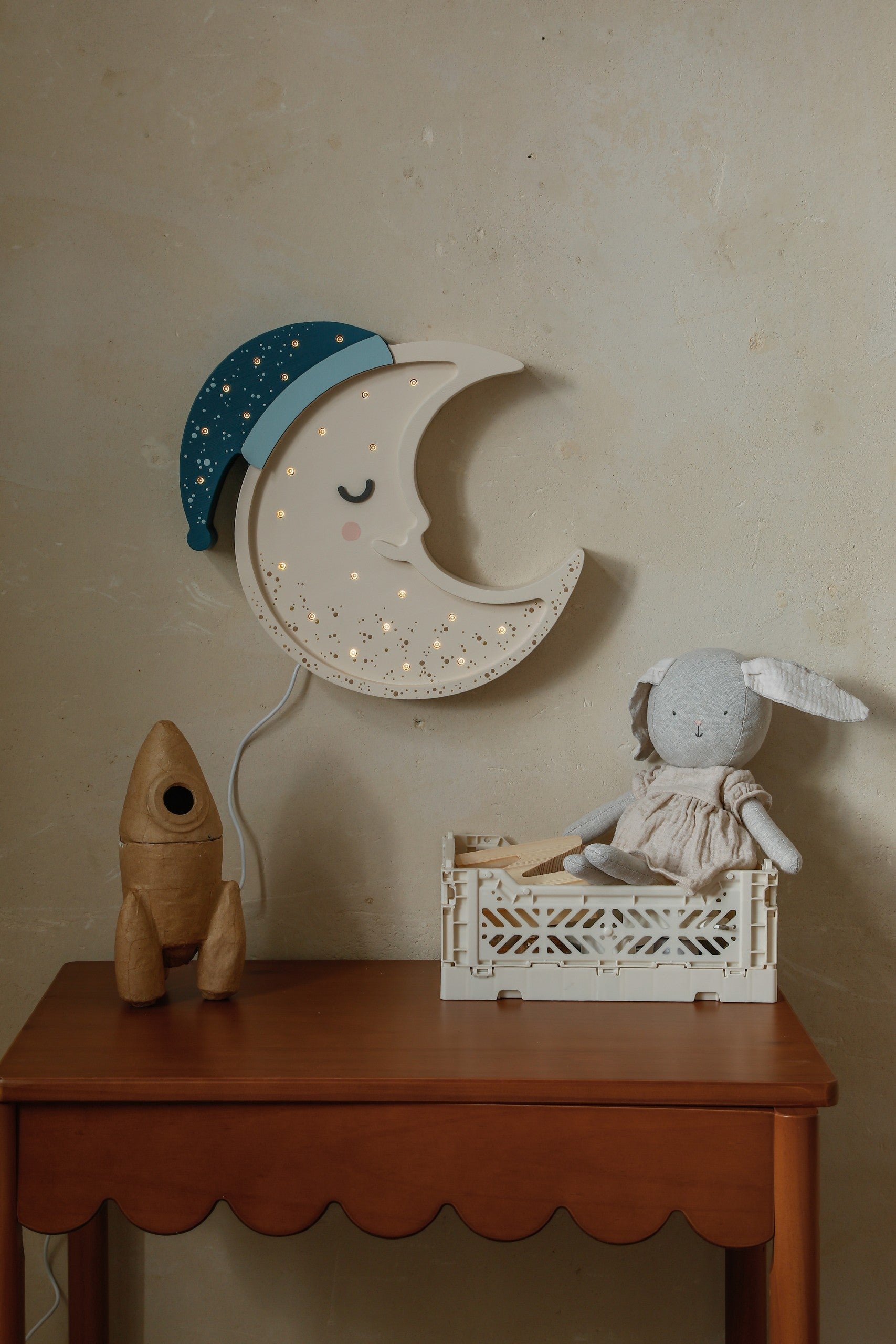 artisan-crafted pinewood moon lamp casting a soft, warm glow on a bedside table